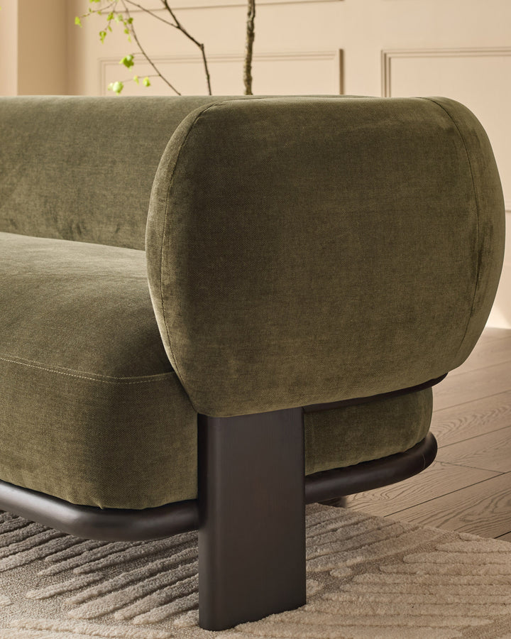 Florence 3-seater sofa in olive green weave fabric with dark wood legs, shown from side angle highlighting curved armrest.