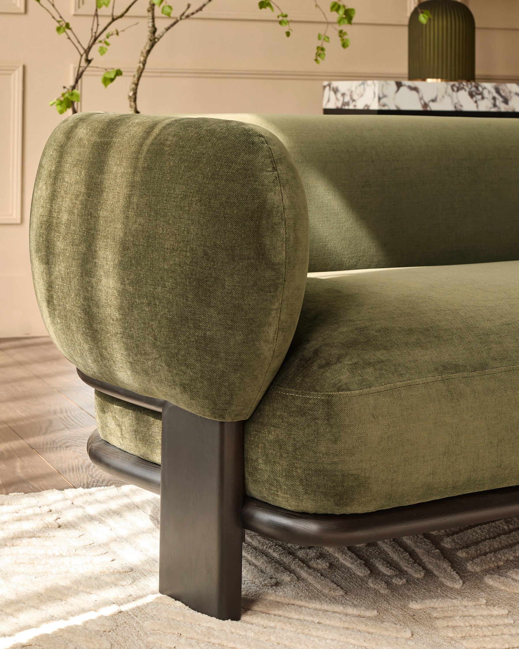 Florence 3-seater sofa in olive green weave fabric with dark wood legs, shown from side angle in living room setting.