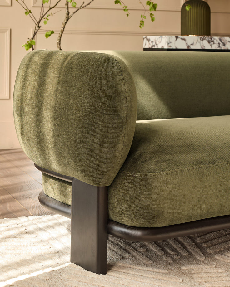 Florence 3-seater sofa in olive green weave fabric with dark wood legs, shown from side angle in living room setting.