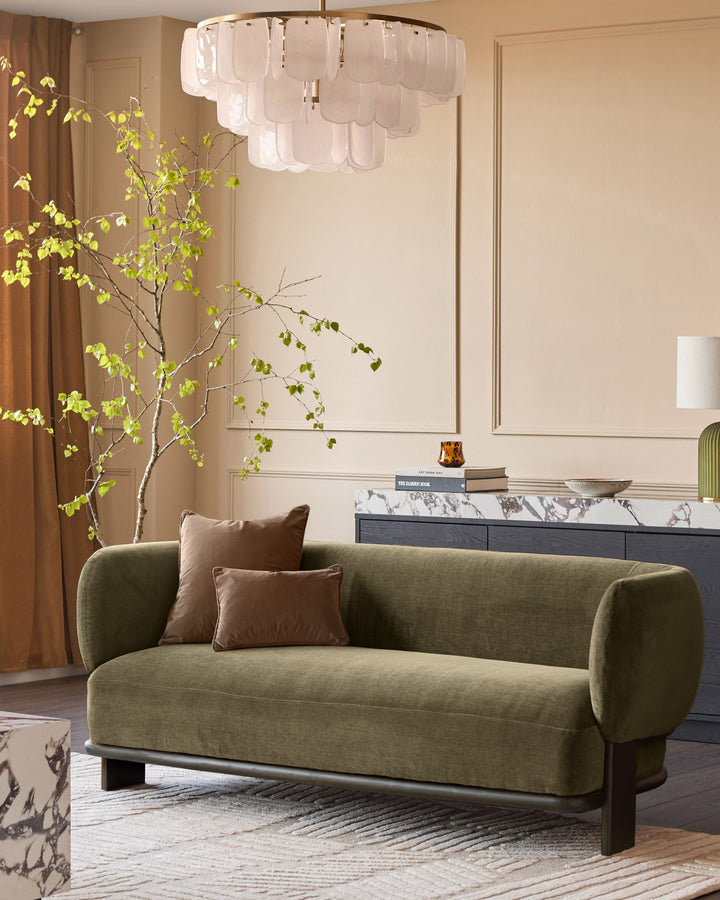 Florence 2-seater sofa in olive green fabric with dark wood base, displayed in a modern living room setting.