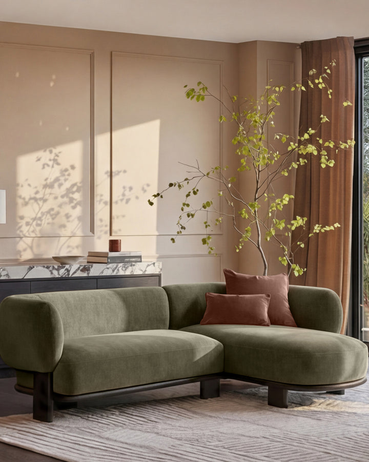 Florence right-hand-facing chaise sofa in olive green fabric with dark wood legs, displayed in a modern living room setting.