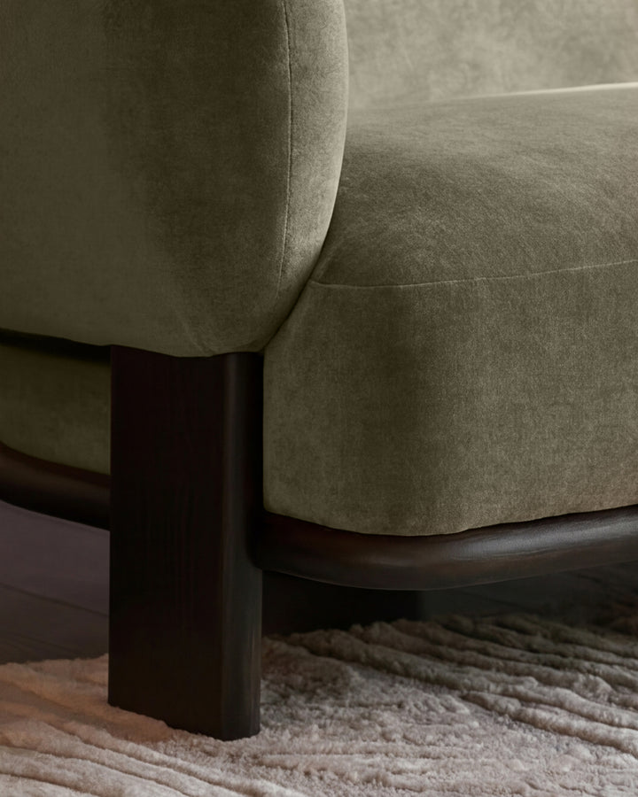 Florence right-hand-facing chaise sofa in olive-green fabric with dark wood legs, shown at a close-up angle on a neutral rug.
