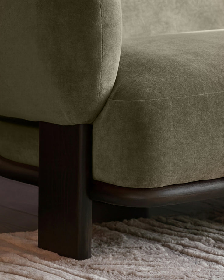 Florence right-hand-facing chaise sofa in olive-green fabric with dark wood legs, shown at a close-up angle on a neutral rug.