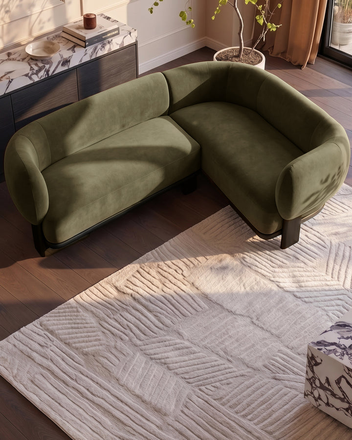 Florence right-hand-facing small corner sofa in olive green fabric with dark wood legs, displayed in a modern living room setting.