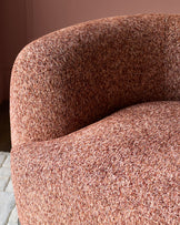 Florence armchair in toffee-red weave fabric, close-up of curved backrest and seat showing textured upholstery detail.