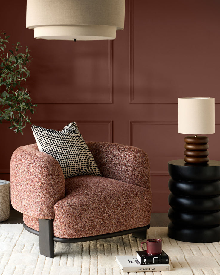 Florence armchair in toffee-red weave fabric with dark wood base, shown in styled room setting with decorative pillow.