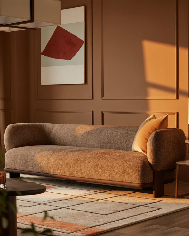 Florence 3-seater sofa in mocha weave fabric with dark wood frame, curved design, shown in warm-lit living room setting.