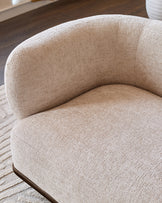 Florence 2-seater sofa in natural fabric with curved design and dark wood base, shown at side angle.