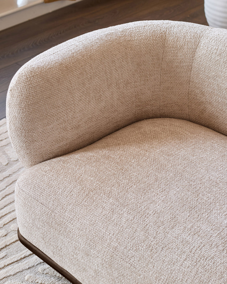 Florence 2-seater sofa in natural fabric with curved design and dark wood base, shown at side angle.
