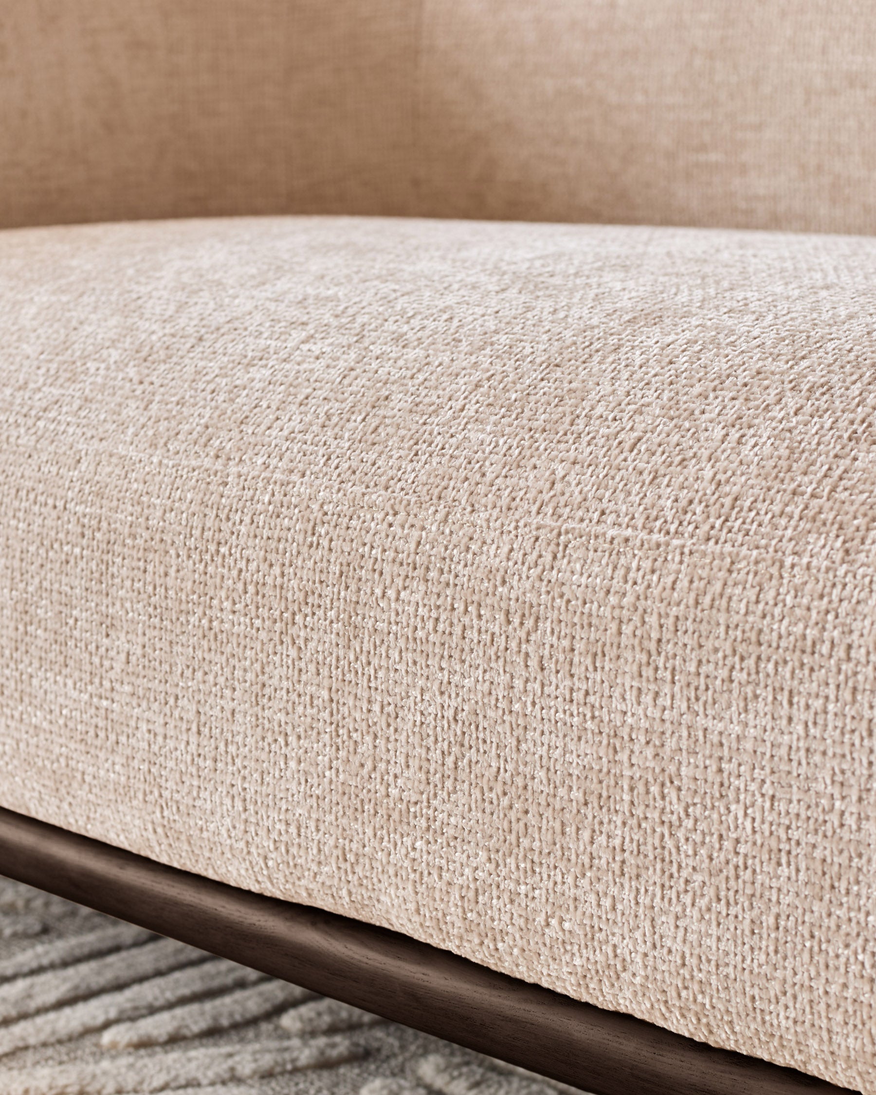 Close-up of Florence 2-seater sofa showing natural fabric texture with dark wood frame detail.