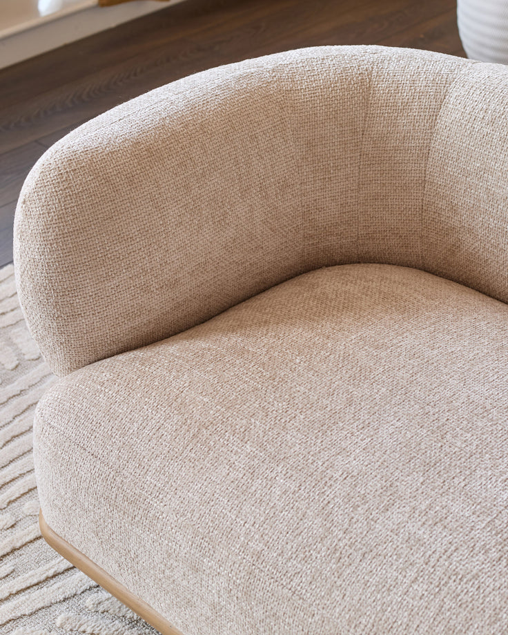 Florence 2-seater sofa in natural fabric with curved back and natural wood base, angled side view.
