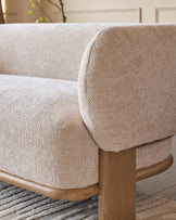 Florence 2-seater sofa close-up showing natural wood frame, rounded armrest, and beige fabric upholstery
