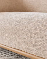 Natural fabric upholstery and wooden frame detail of the Florence 2-seater sofa in natural tones.