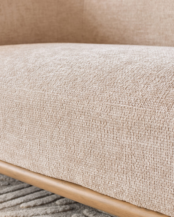 Natural fabric upholstery and wooden frame detail of the Florence 2-seater sofa in natural tones.