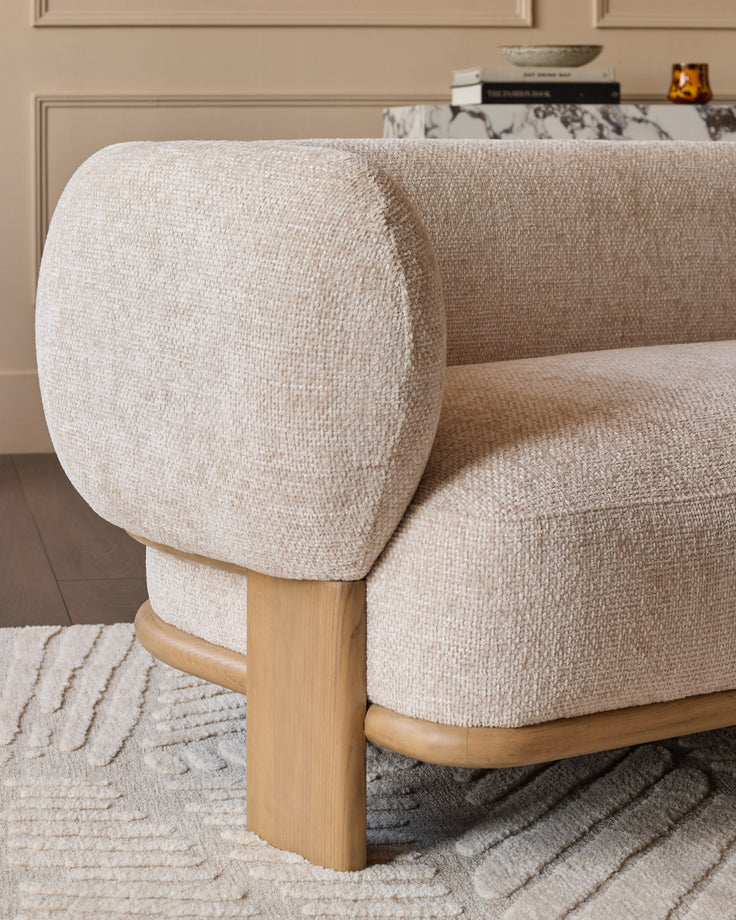 Florence 2-seater sofa in natural linen fabric with natural wood legs, curved armrest detail visible.