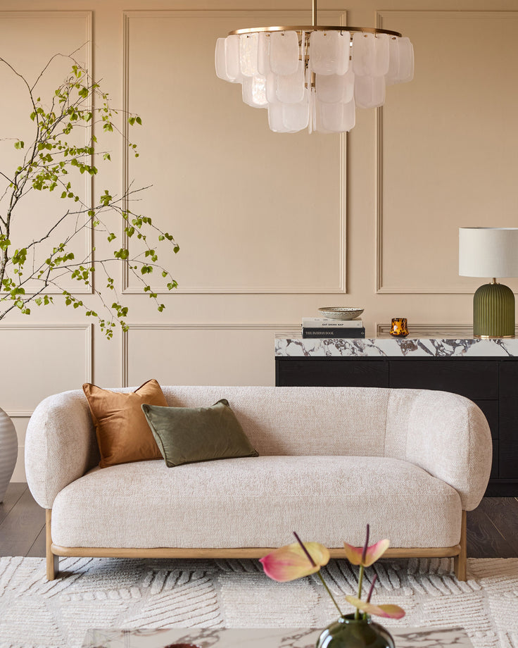 Florence 2-seater sofa in natural linen fabric with natural wood frame, curved design, styled in living room setting.