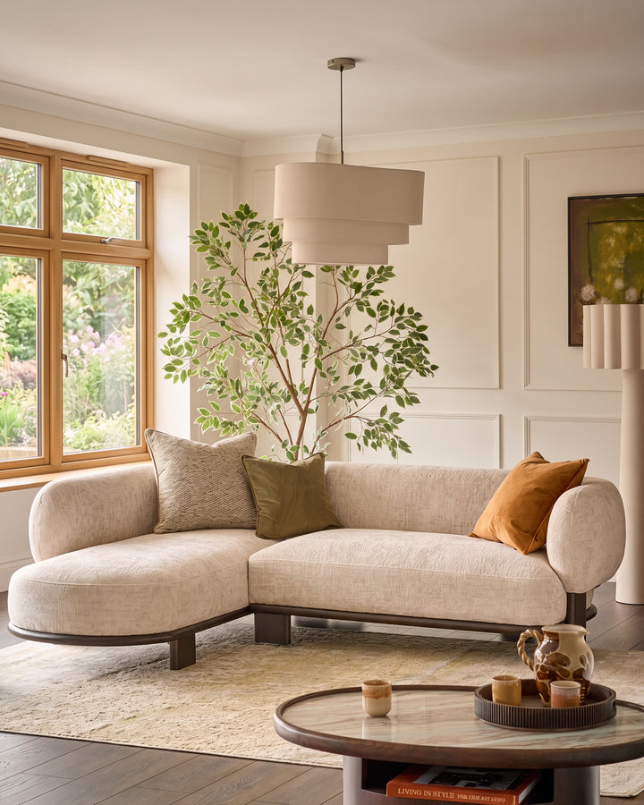 Florence left-hand-facing chaise sofa in natural fabric with dark wood legs, shown in a modern living room setting.