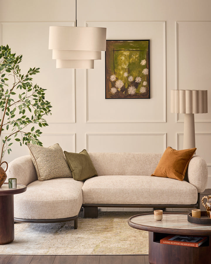 Florence left-hand-facing chaise sofa in natural fabric with dark wood base, styled in a modern living room setting.