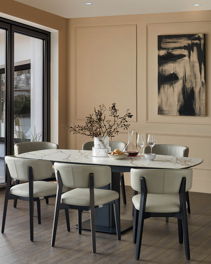 Dining room with a marble table surrounded by six chairs, plus a contemporary piece of art on the wall.