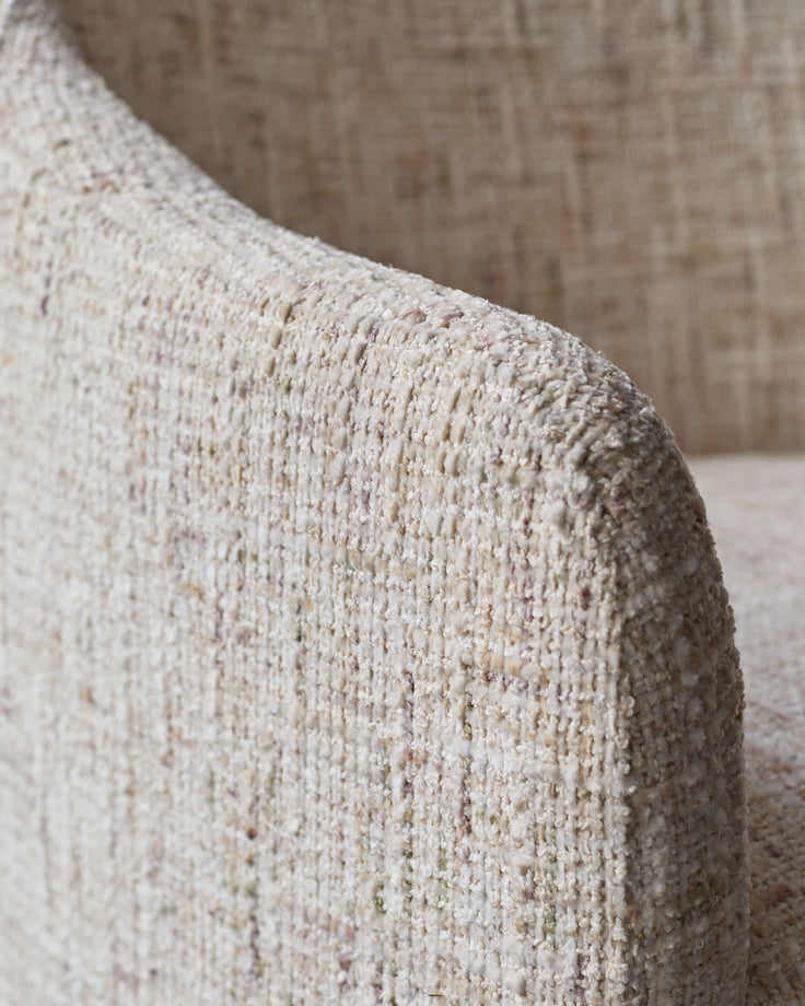Close-up of natural beige woven fabric on Freya dining chair, showing textured weave detail.