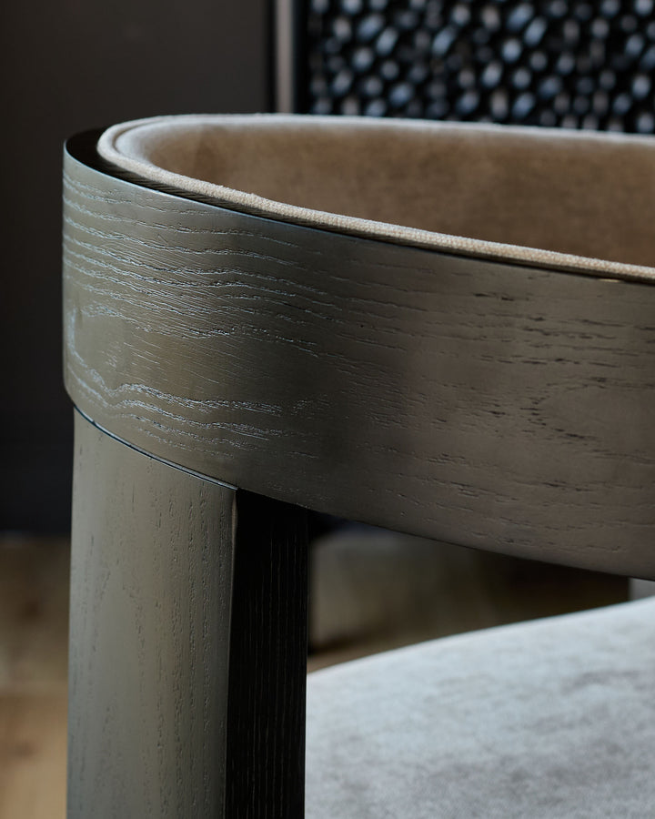 Garcia dining chair in champagne fabric, close-up of curved wooden frame detail and upholstered seat.