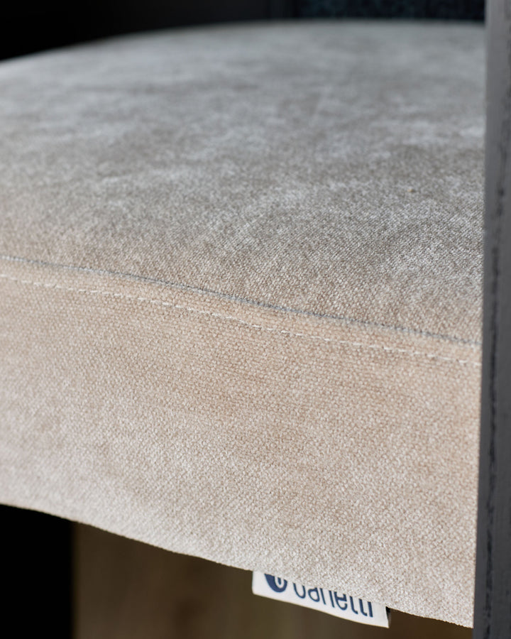 Close-up of champagne-colored fabric texture on Garcia dining chair, showing weave detail and color gradation.