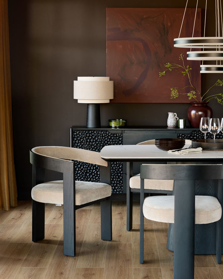 Garcia dining chair in champagne fabric with curved wooden backrest, shown in modern dining setting.