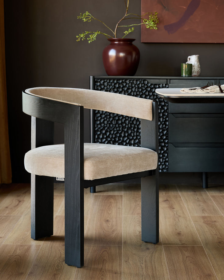Garcia dining chair in champagne fabric with dark wood frame, shown in modern dining room setting.