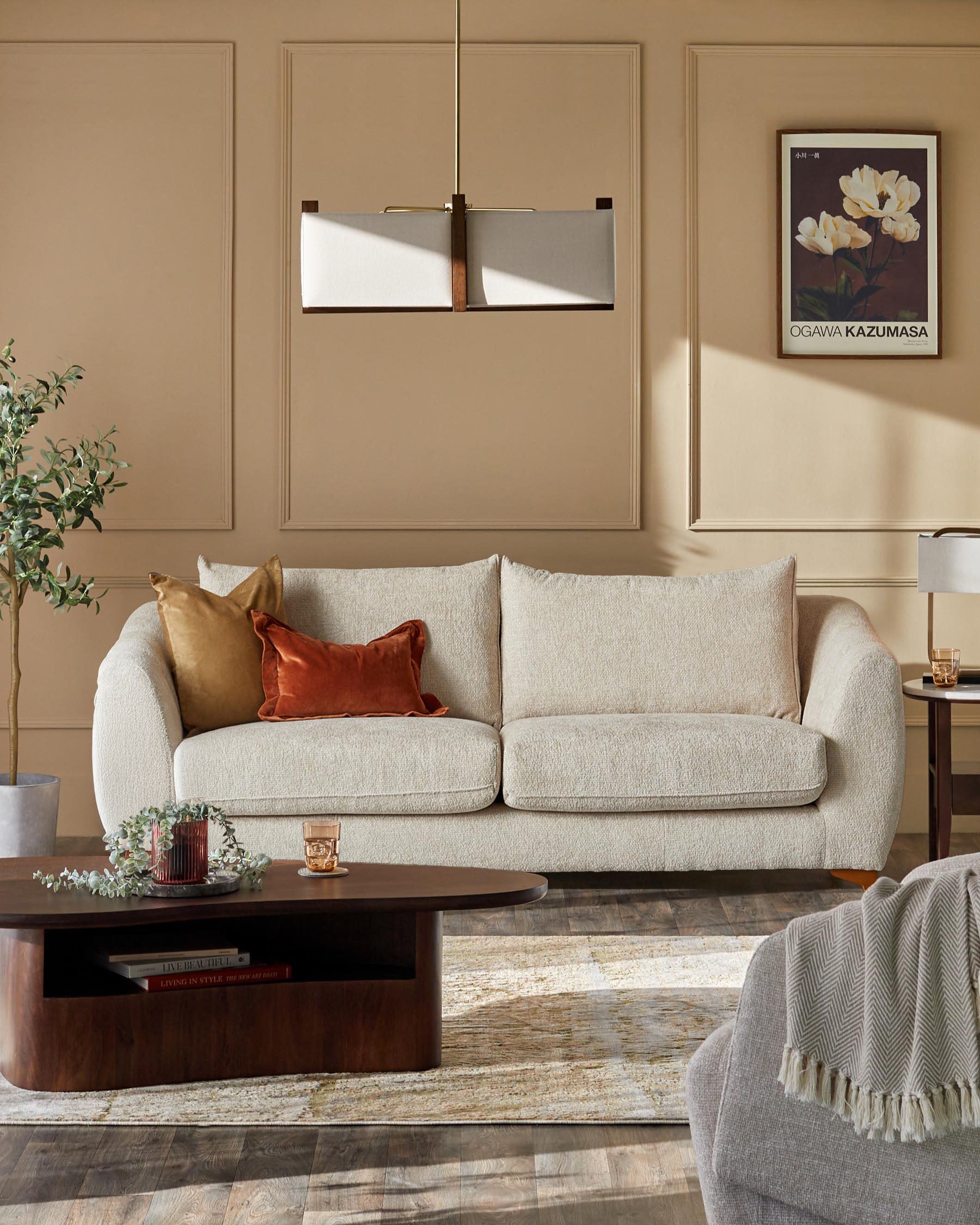 Genevieve 2-seater sofa in natural weave, shown in warm living room with decorative cushions and wooden coffee table.