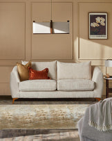 Genevieve 2-seater sofa in natural weave with wood legs, styled in a neutral living room setting.