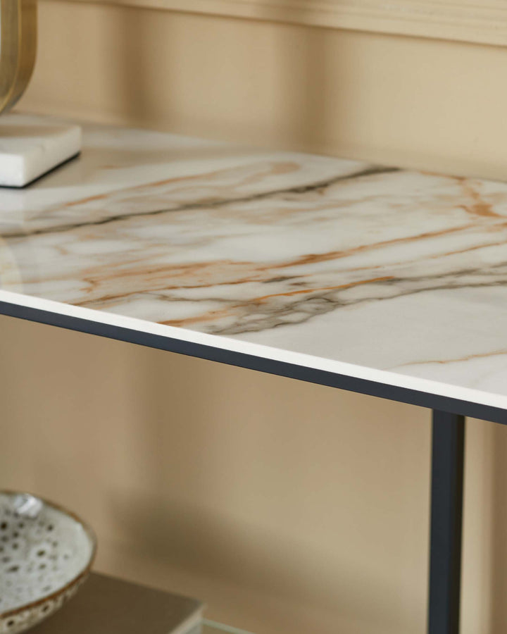Close-up of a console table with a marble top and dark metal frame, showcasing modern design and elegant details.