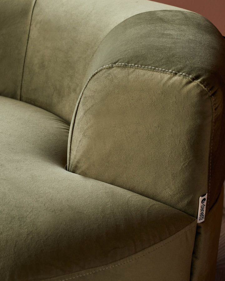 Close-up of an olive-green sofa, showcasing its soft, textured fabric and neat stitching detail.