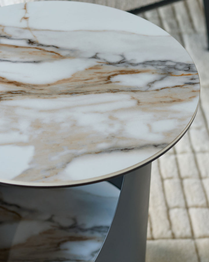 Giotto side table with round marble top in natural white and brown tones, featuring a pedestal base in soft Grey.