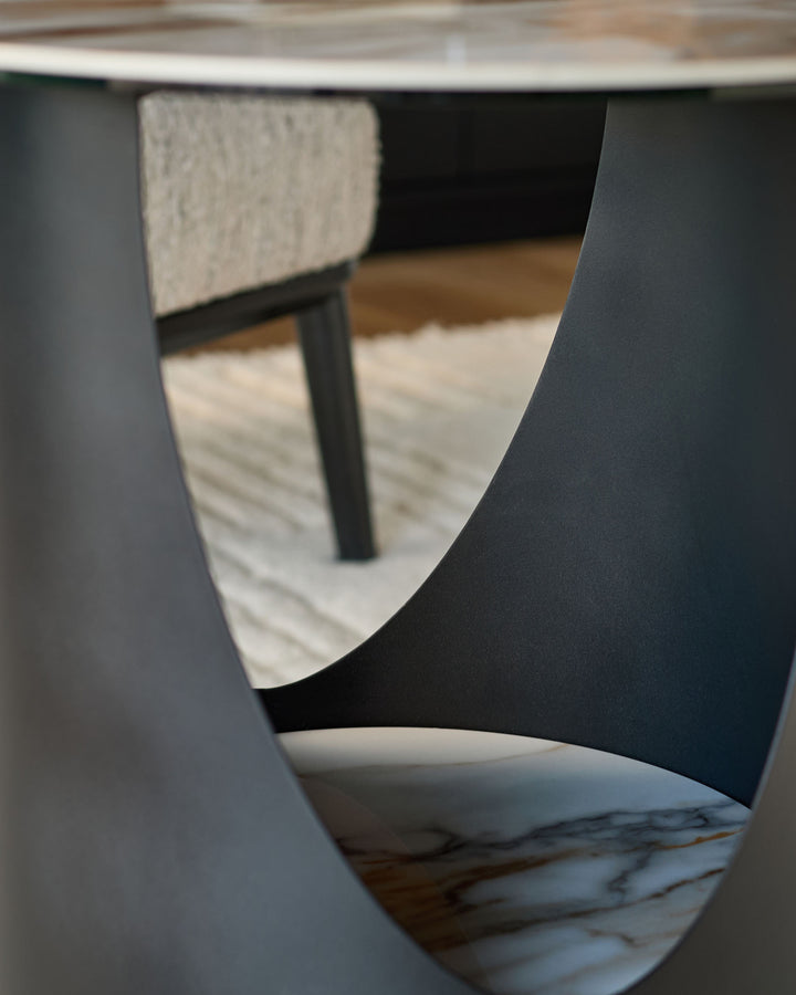 Giotto side table in ceramic, natural finish, shown from close-up angle highlighting curved edges and marble-effect base detail.