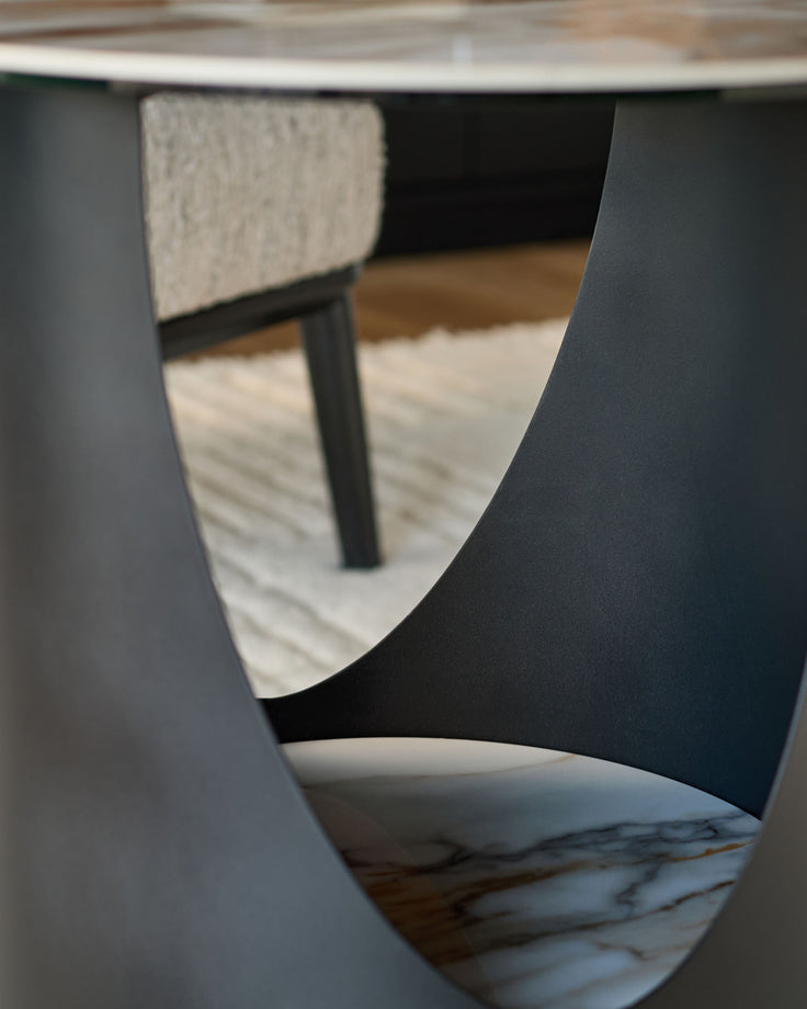 Giotto side table in ceramic, natural finish, shown from close-up angle highlighting curved edges and marble-effect base detail.
