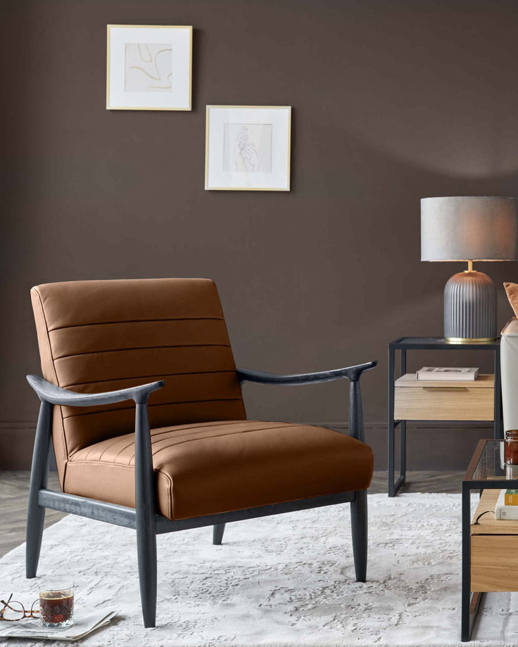 Greyson tan leather accent chair with charcoal wood frame and arms, shown in a styled living room setting.