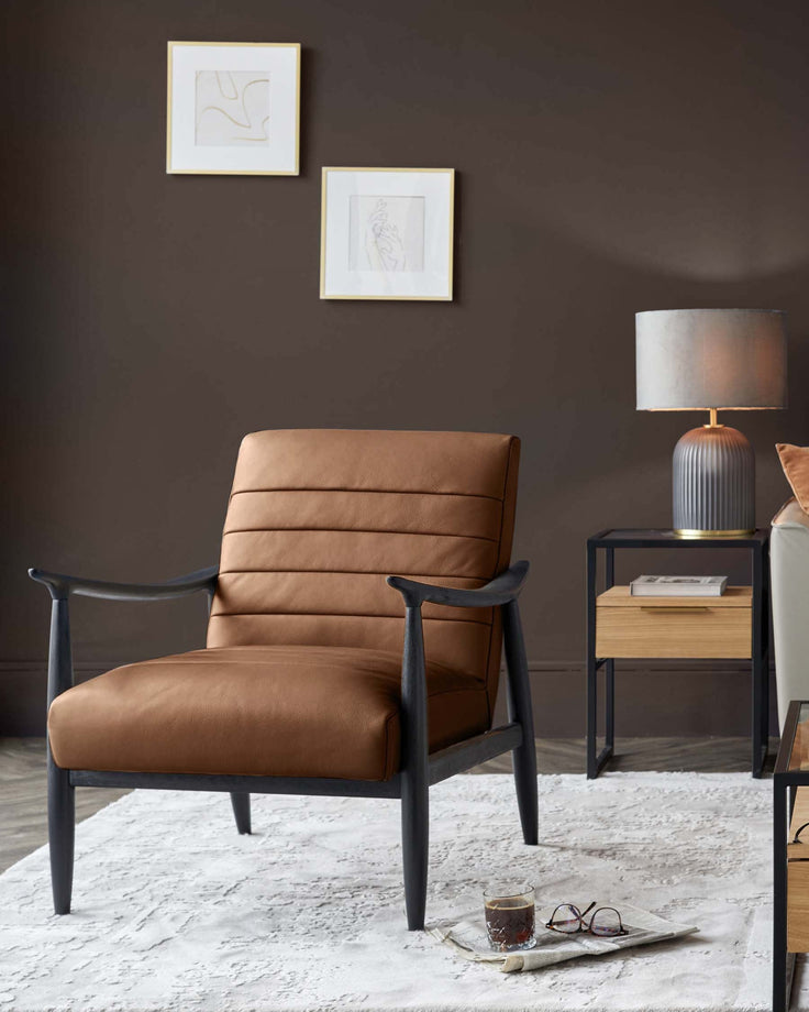 Tan leather accent chair with black wooden arms and legs, displayed in a modern living room setting.