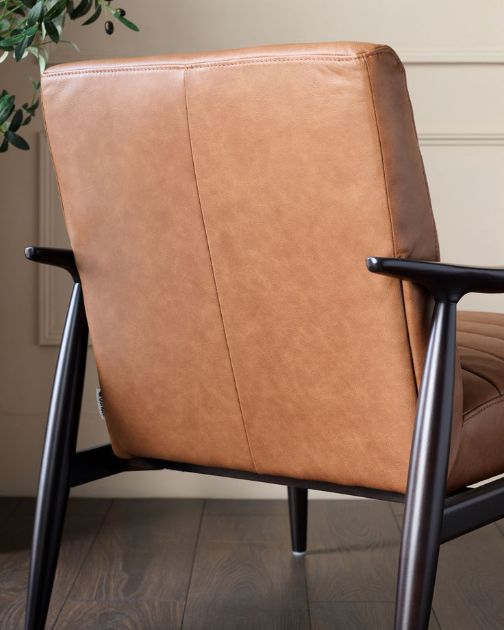 Greyson Leather Accent Chair in tan, rear view showing cognac leather back and black wooden frame arms.