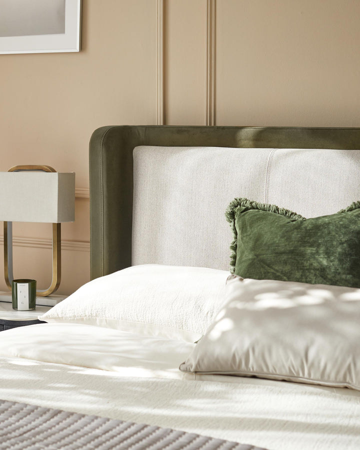 Stylish bed with a textured headboard, comfy pillows, and a lamp on the bedside table creating a relaxing ambience.