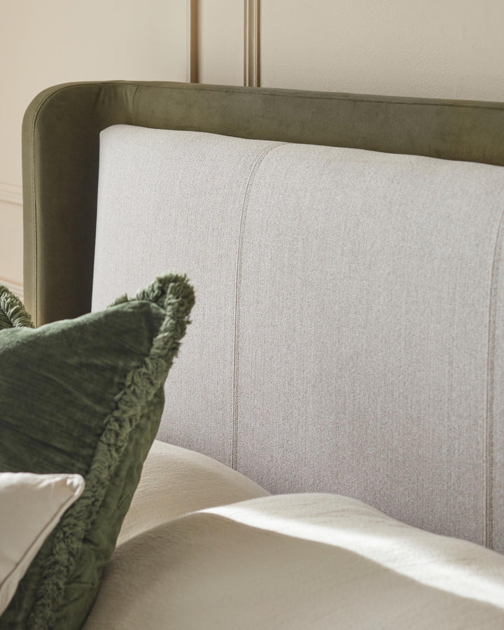 Close-up of a stylish bed with a textured headboard and soft cushions, creating a cosy and inviting atmosphere.