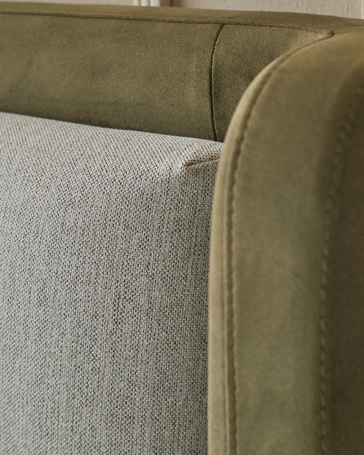 Close up of the fabric detailing on a moss green and neutral coloured sofa.