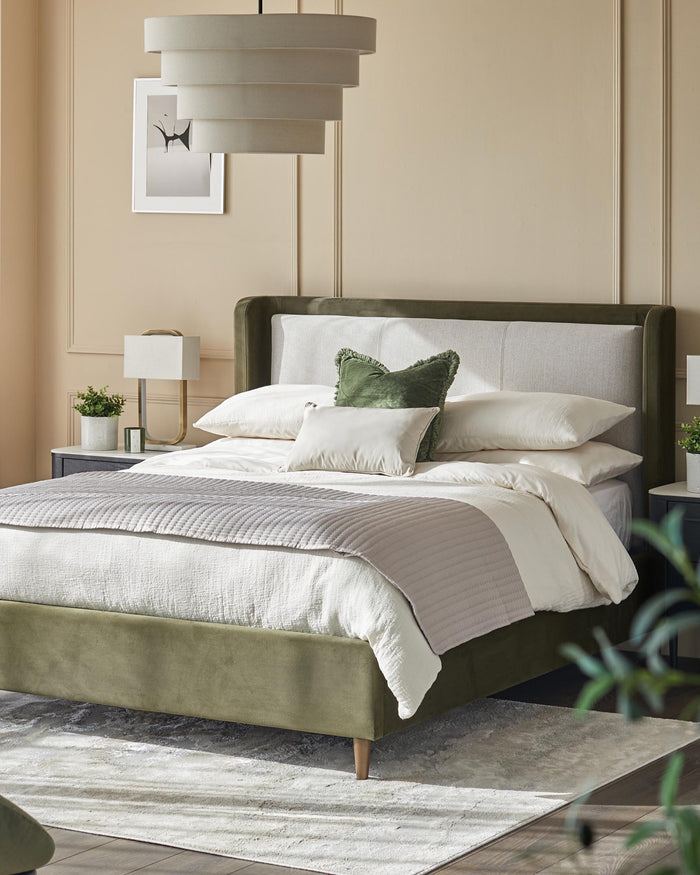 A stylish bedroom featuring a luxurious bed with an olive green frame and light grey headboard, creating a serene and elegant space.