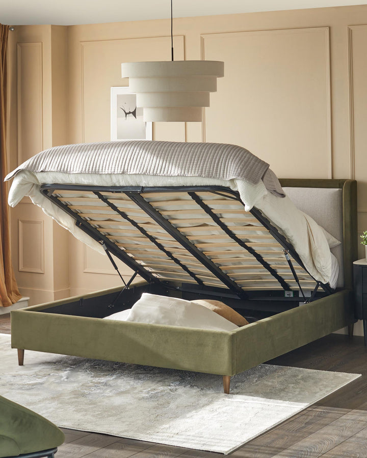 An olive green ottoman bed with lift-up frame exposing storage space, plus other bedroom furniture.