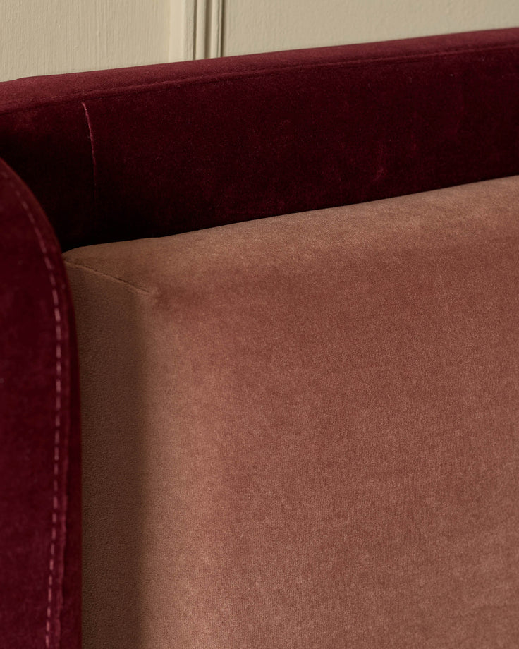 Grove King ottoman bed in velvet, showing rose and plum two-tone upholstery detail at close range.