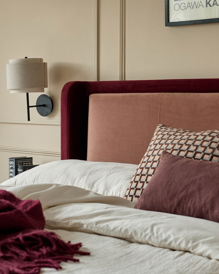Grove King Ottoman Bed in rose pink and plum velvet, styled with coordinating bedding and wall-mounted lamp.