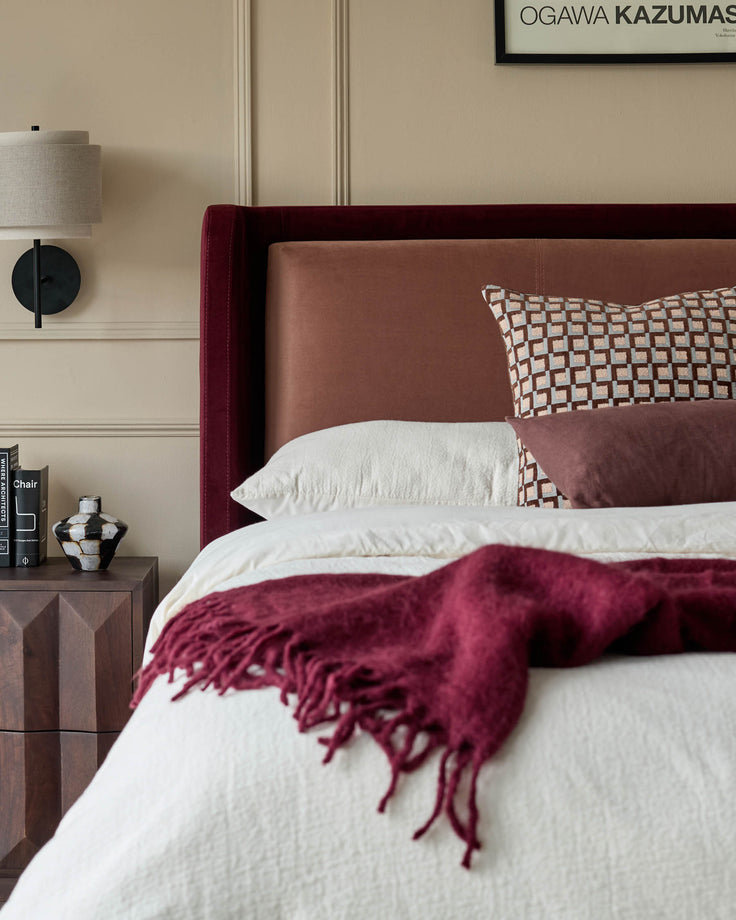 Grove King Ottoman Bed in rose and plum velvet with coordinating bedding and bedroom styling.
