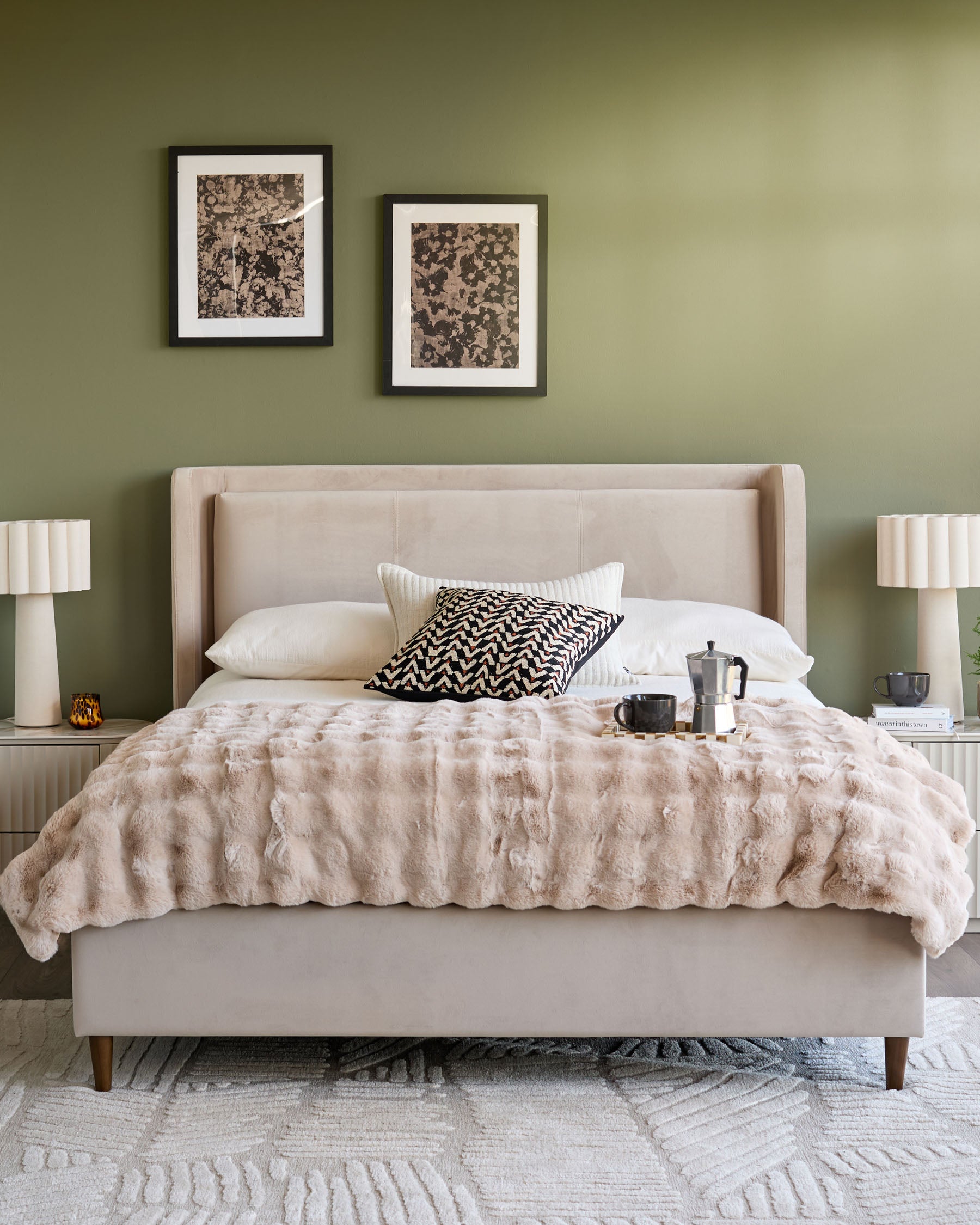 Grove King Ottoman Bed in champagne velvet, displayed in a styled bedroom with neutral bedding and sage green walls.