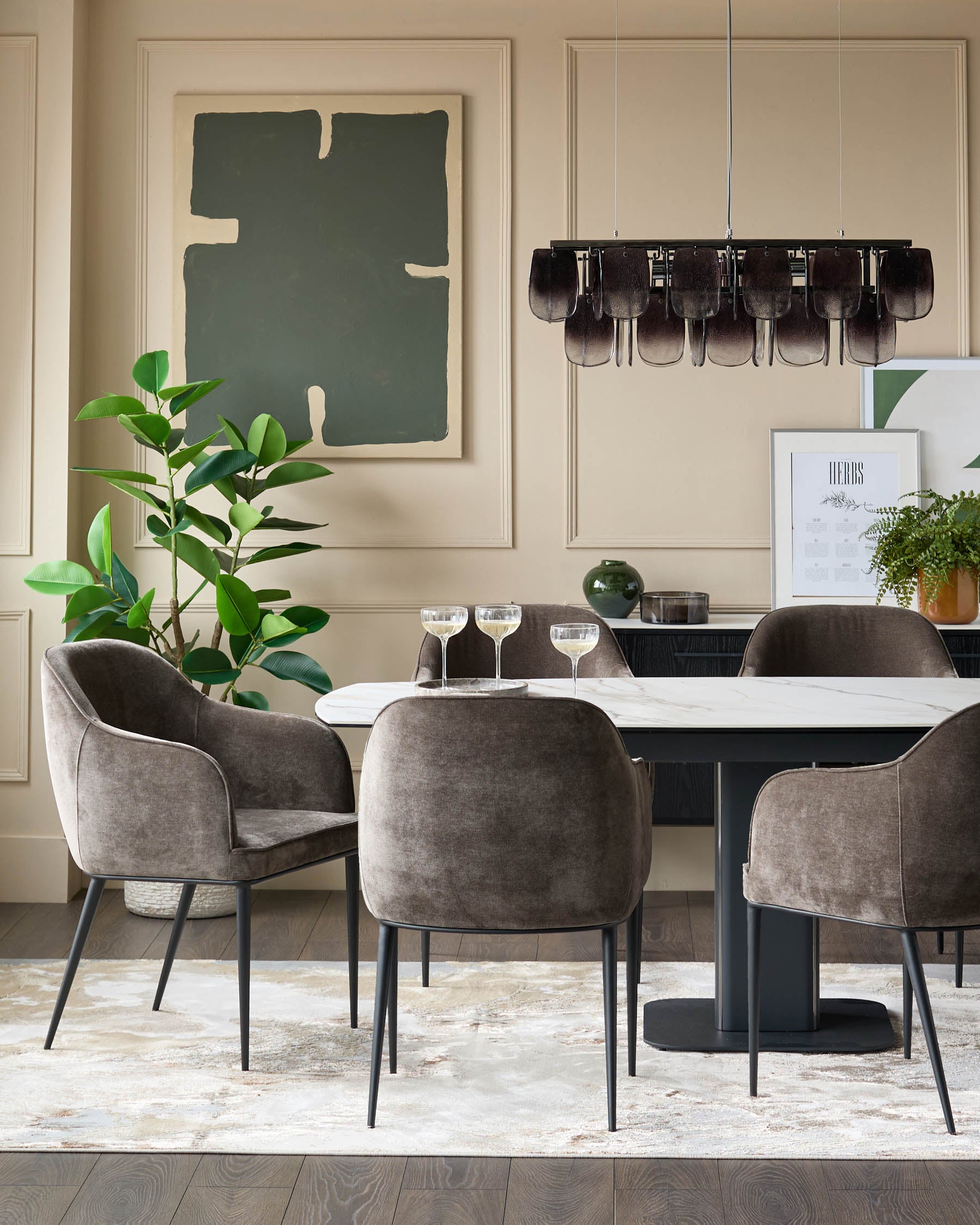 Dining room with marble-top table, velvet chairs, and modern chandelier, exuding elegance and style.