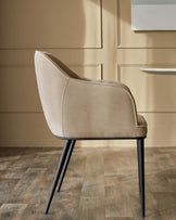 A stylish beige upholstered dining chair with sleek black metal legs, adding a touch of modern elegance to any dining space.
