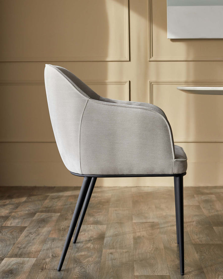 Grey upholstered chair with black metal legs. Stylish and modern dining or accent chair.